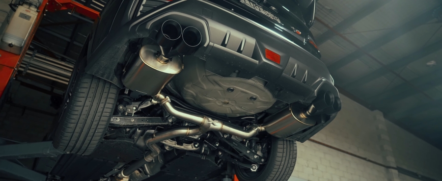 High-performance dual XForce exhaust system installed on a sports car.