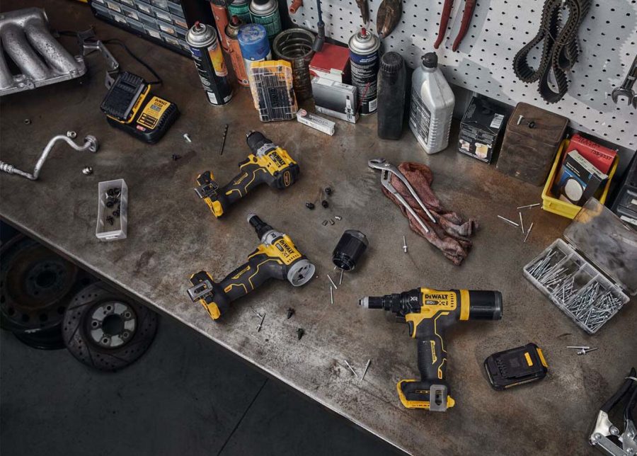 Workshop scene with various DeWalt power tools and accessories on workbench.